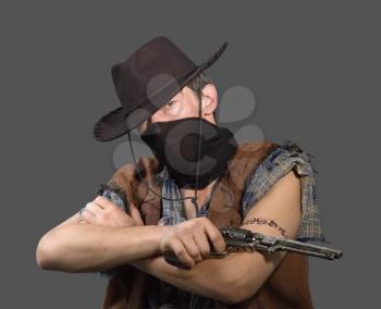 cowboy with revolver isolated on grey background.Shallow DOF