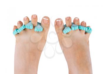 female feet with french polished nails and funny equipment isolated on white