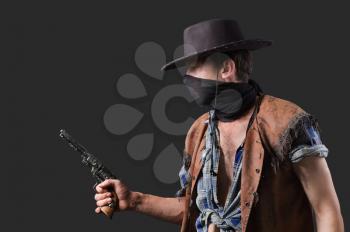 cowboy with revolver in his hand  on dark background