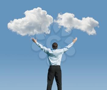beautiful clouds and happy young man with his hands up.Concept image on cloud computing and rest