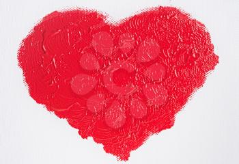 red heart painted with acrylic paint on white canvas