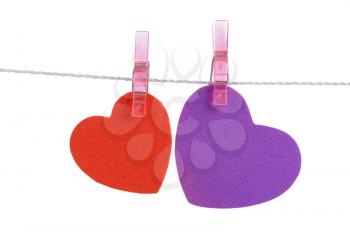 
two foam shapes hearts pinned together isolated on white background