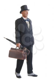 Middle aged  businessman in a retro business suit with valise and umbrella isolated on white