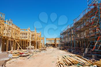 Construction site with the house in scaffolding against a blue sky