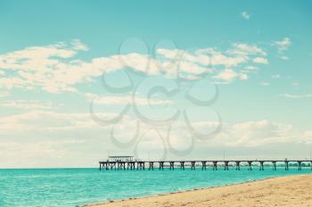 Beautiful Sea landscape with Grange Jetty Adelaide Australia and people silhouettes. Toning in retro style