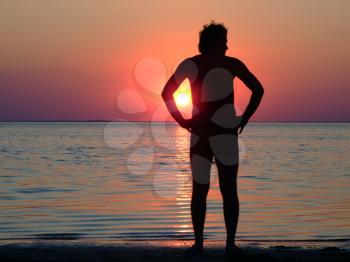 Royalty Free Photo of a Man Silhouetted on a Beach