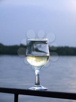 Royalty Free Photo of a Glass of Wine With Water in the Background