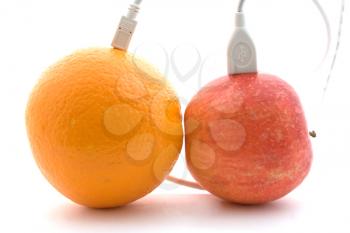 Royalty Free Photo of Cords Connecting an Orange and Apple