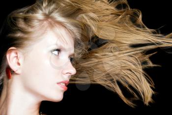 Royalty Free Photo of a Woman Looking at Her Hair Moving to the Side