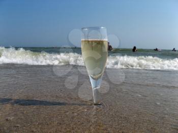 Royalty Free Photo of a Glass of Champagne on the Beach