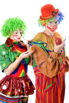 Royalty Free Photo of a Couple of Clowns With an Apple