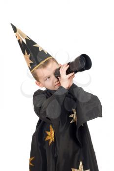 Royalty Free Photo of a Little Boy Dressed Like a Wizard ad Looking Through a Telescope