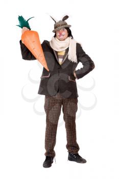 Royalty Free Photo of a Man in Rabbit Ears Holding a Carrot