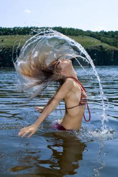 Royalty Free Photo of a Woman Flinging her Hair in Water
