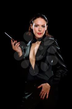 Royalty Free Photo of a Woman in a Black Suit Holding a Cigarette
