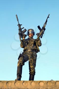 Royalty Free Photo of a Soldier With Two Rifles