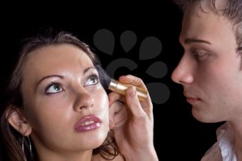 Royalty Free Photo of a Man Applying a Woman's Makeup