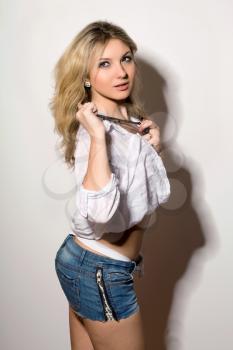 Sexy blond young woman in a white shirt