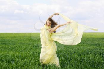Attractive expressive young woman in a green field