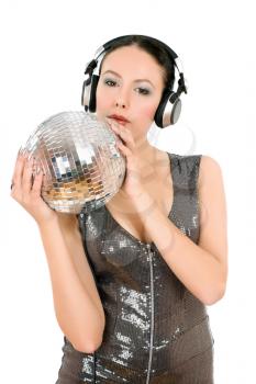 Beautiful young woman in headphones with a mirror ball. Isolated