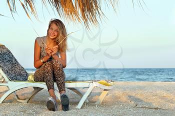 Funny teen girl sitting on a lounge chair