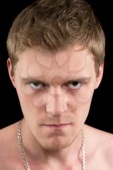 Closeup portrait of a angry young man. Isolated
