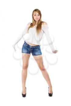 Young leggy woman wearing jeans shorts, white blouse and black shoes. Isolated