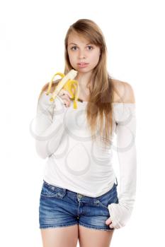 Young blond woman in blue jeans shorts holding banana. Isolated on white