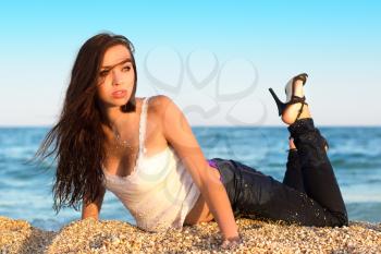 Attractive young caucasian woman posing on the beach