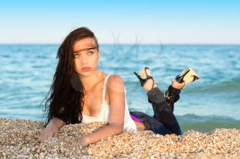 Young pretty thoughtful caucasian woman posing on the sand