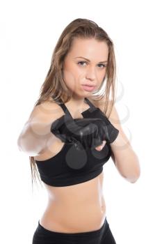 Portrait of young woman boxing in the studio. Isolated on white