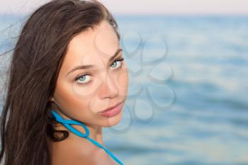 Portrait of pretty young lady posing on the beach