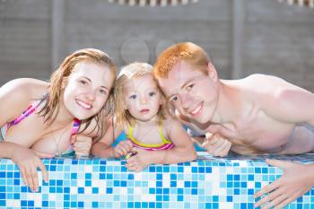 Nice positive family posing in the water pool