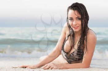Pretty playful brunette posing near the sea