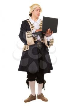 Eccentric young man in medieval costume posing with a laptop. Isolated on white