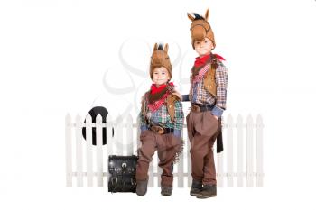 Two boys in carnival costumes posing near the fence. Isolated on white