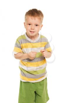 Funny little boy in striped t-shirt and green shorts. Isolated on white
