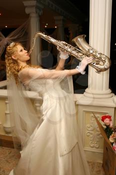 Royalty Free Photo of a Bride Playing the Saxophone
