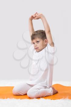Royalty Free Photo of a Little Boy Doing yoga