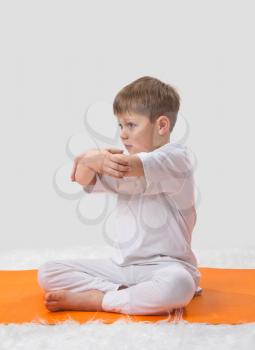 Royalty Free Photo of a Little Boy Doing Yoga