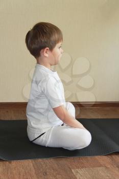 Royalty Free Photo of a Little Boy Practicing Yoga