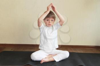 Royalty Free Photo of a Little Boy Practicing Yoga