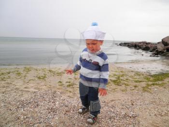 Royalty Free Photo of a Little Boy Walking at the Beach