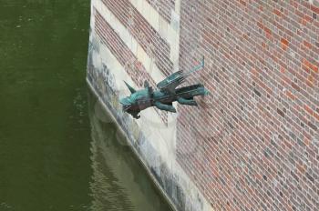 Gargoyle in the castle wall Heeswijk. Netherlands