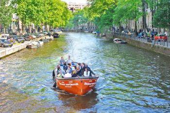 Tourists on a boat in Amsterdam, Netherlands
