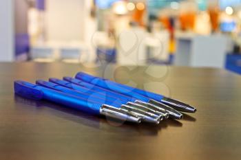 Several pens on the table at the exhibition