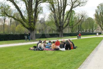 BRUSSELS, BELGIUM - APRIL 8, 2012: Group of youths at a picnic in spring Jubelpark  Brussels, Belgium 