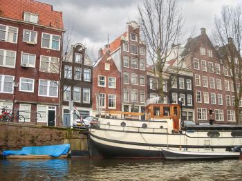   Houses and boats on the canal in Amsterdam . Netherlands