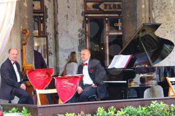 VENICE, ITALY - MAY 06, 2014: Musicians on the terrace under the canopy of the world famous Cafe Florian in Piazza San Marco in Venice, Italy