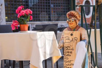 VENICE, ITALY - MAY 06, 2014: Mannequin welcoming cook in an outdoor cafe,Venice, Italy